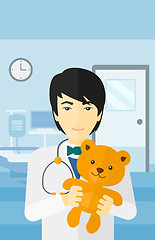 Image showing Pediatrician holding teddy bear.