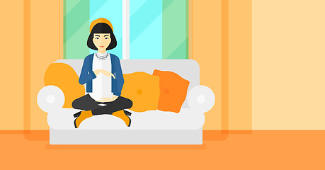 Image showing Pregnant woman sitting on sofa.