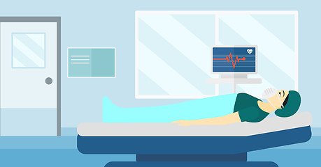 Image showing Patient lying in hospital bed with heart monitor.