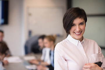 Image showing hispanic businesswoman with tablet at meeting room