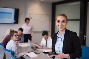 Image showing business woman working on tablet at meeting room