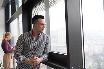 Image showing business man at office looking through window