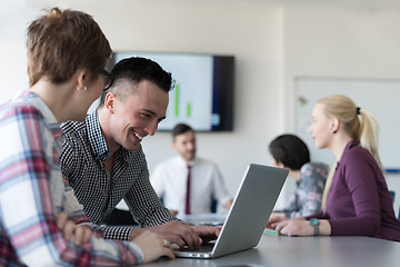 Image showing young business couple working on laptop, businesspeople group on