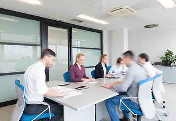 Image showing business people group entering meeting room, motion blur