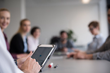 Image showing close up of  businessman hands  using tablet on meeting