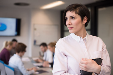 Image showing hispanic businesswoman with tablet at meeting room