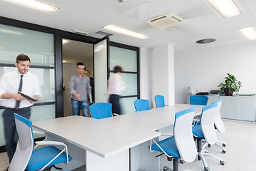 Image showing business people group entering meeting room, motion blur