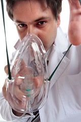 Image showing Doctor putting on oxygen mask