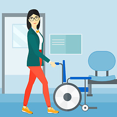 Image showing Woman pushing wheelchair.