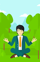 Image showing Businessman meditating in lotus pose.