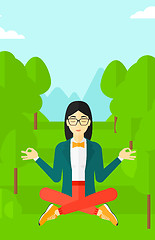 Image showing Business woman meditating in lotus pose.