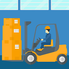 Image showing Warehouse worker moving load by forklift truck.