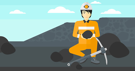 Image showing Miner holding coal in hands.