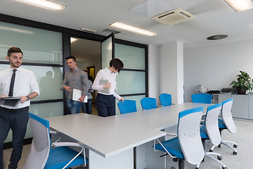 Image showing business people group entering meeting room, motion blur