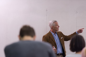 Image showing teacher with a group of students in classroom