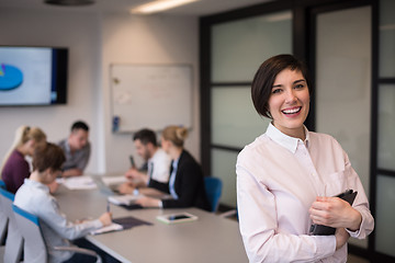 Image showing hispanic businesswoman with tablet at meeting room