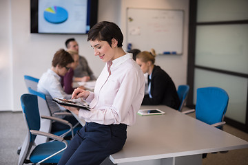 Image showing hispanic businesswoman with tablet at meeting room