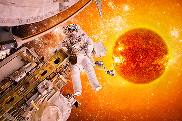 Image showing Spacecraft and astronauts in space on background sun star