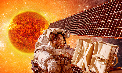 Image showing Spacecraft and astronauts in space on background sun star