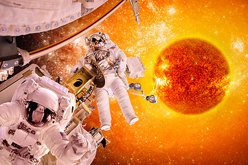 Image showing Spacecraft and astronauts in space on background sun star