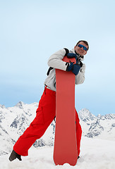 Image showing Man with red snowboard