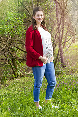 Image showing Pregnant woman in red jacket with calendar on her T-shirt 