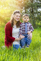 Image showing beautiful pregnant woman outdoor with her little boy 