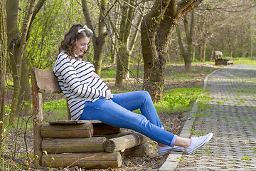 Image showing beautiful pregnant woman outdoor in the park on banch