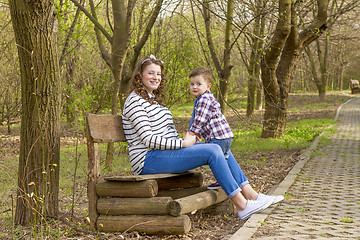 Image showing beautiful pregnant woman outdoor with her little boy