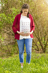 Image showing Pregnant woman in red jacket 