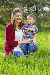 Image showing beautiful pregnant woman outdoor with her little boy