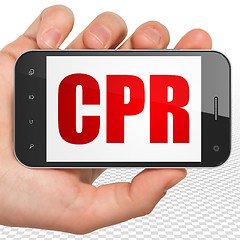 Image showing Health concept: Hand Holding Smartphone with CPR on display