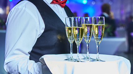 Image showing Waiter serving champagne on a tray