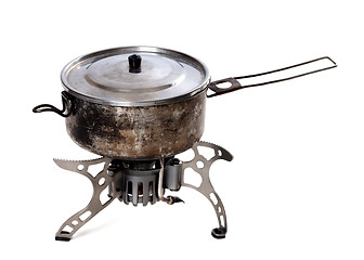 Image showing Camping gas stove and old sooty hiking pan