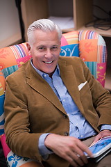 Image showing portrait of handsome teacher in colorful chair