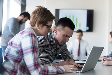 Image showing young business couple working on laptop, businesspeople group on