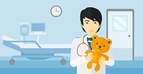 Image showing Pediatrician holding teddy bear.