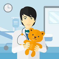 Image showing Pediatrician holding teddy bear.