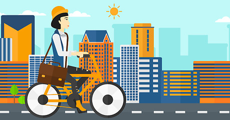 Image showing Woman cycling to work.