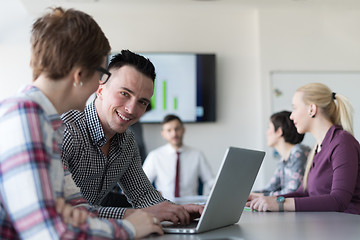 Image showing young business couple working on laptop, businesspeople group on