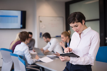 Image showing business woman on meeting  using tablet