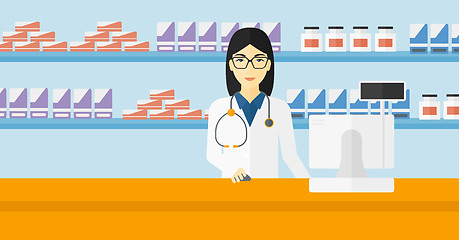 Image showing Pharmacist at counter with computer monitor.