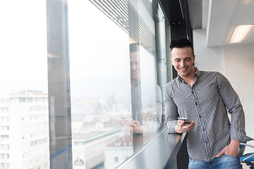 Image showing young business man using smart phone at office