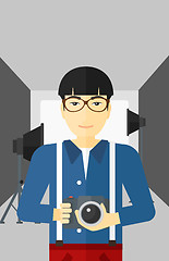 Image showing Smiling photographer holding camera.