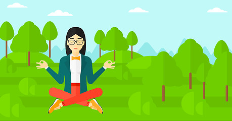 Image showing Business woman meditating in lotus pose.