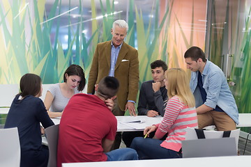 Image showing teacher with a group of students in classroom