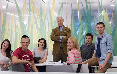 Image showing portrait of  teacher with students group in background