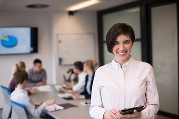 Image showing hispanic businesswoman with tablet at meeting room