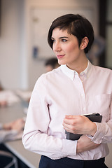 Image showing hispanic businesswoman with tablet at meeting room