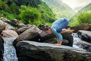 Image showing Woman doing Bakasana asana outdoors